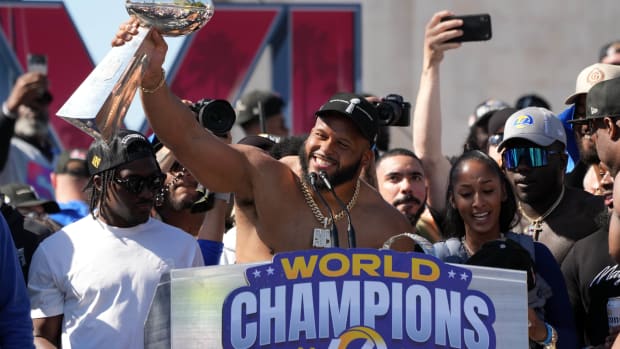 Feb 16, 2022; Los Angeles, CA, USA; Los Angeles Rams defensive end Aaron Donald holds the Vince Lombardi trophy during the Super Bowl LVI championship rally at the Los Angeles Memorial Coliseum. Mandatory Credit: Kirby Lee-USA TODAY Sports
